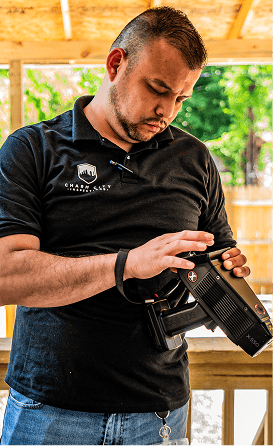 A Charm City Inspections inspector holding a handheld lead paint analyzer on a porch