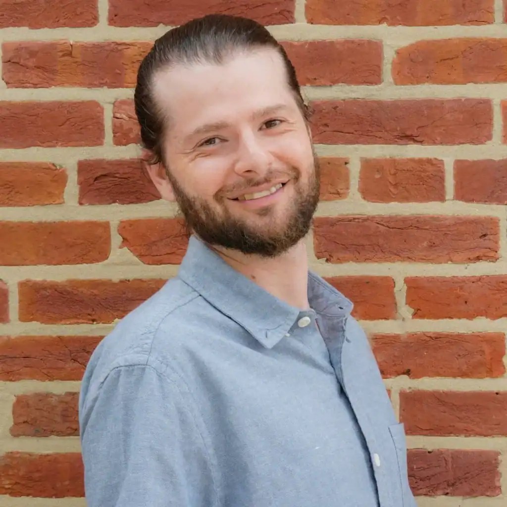 Professional home inspector from Charm City Inspections smiling outdoors.